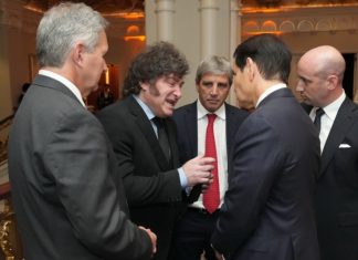 Milei desesperado busca un foto con Trump